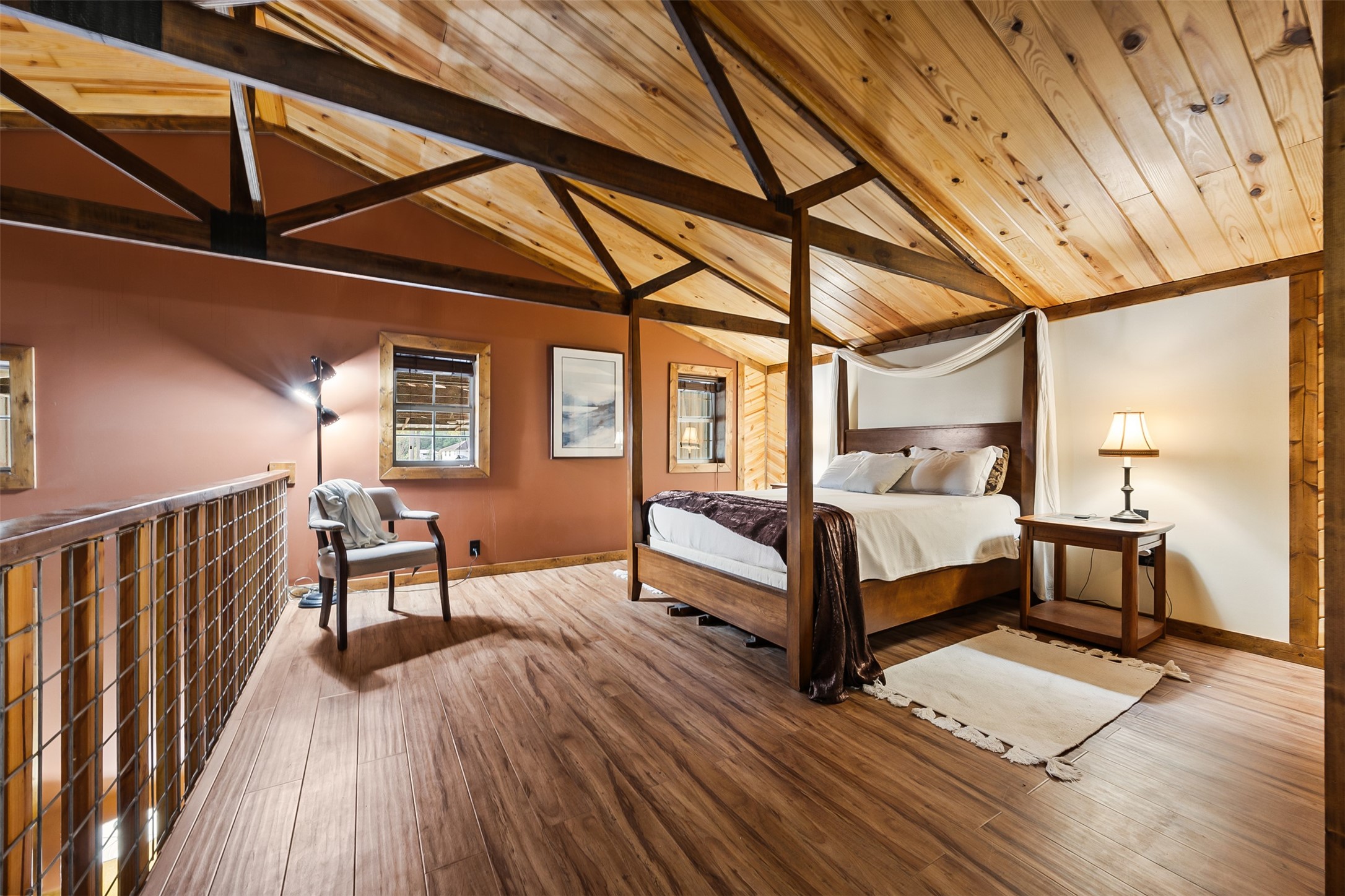 40 Olson Road New Waverly, TX 77358 - Photo 22 of 34 a bedroom with a bed and wooden floor