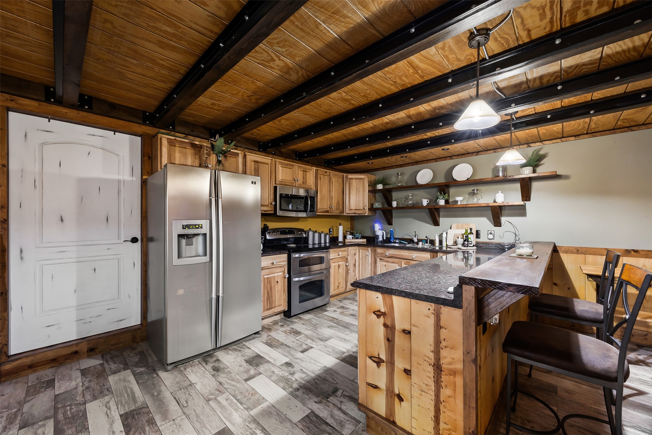 40 Olson Road New Waverly, TX 77358 - Photo 9 of 34 a kitchen with refrigerator and chairs