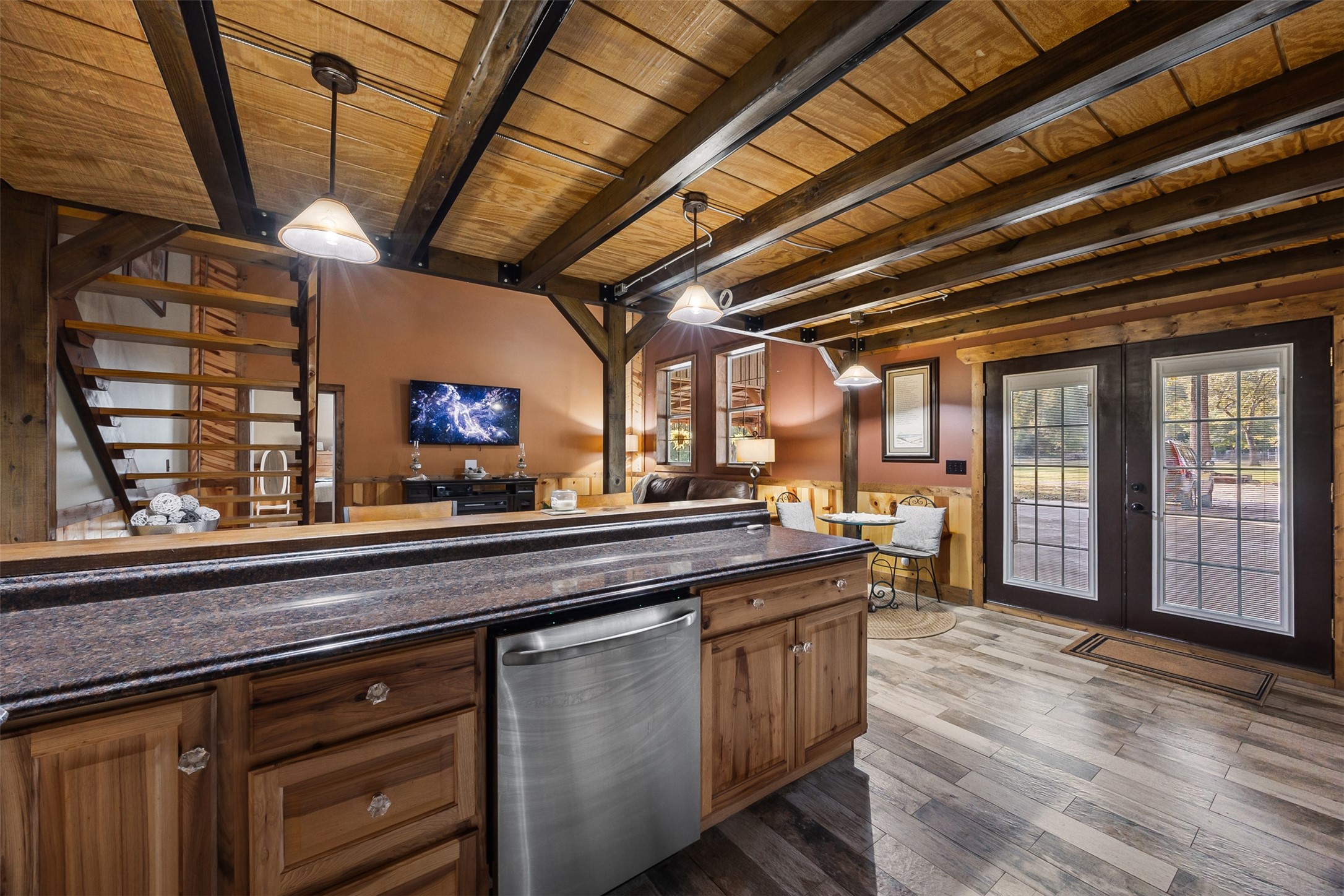 40 Olson Road New Waverly, TX 77358 - Photo 10 of 34 a open kitchen with stainless steel appliances granite countertop a sink a counter space wooden floors and a fireplace