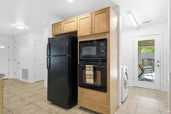 a kitchen with stainless steel appliances granite countertop a refrigerator and a sink