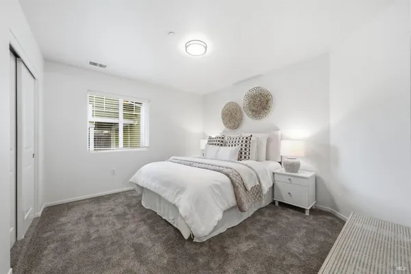 a bedroom with a bed and window