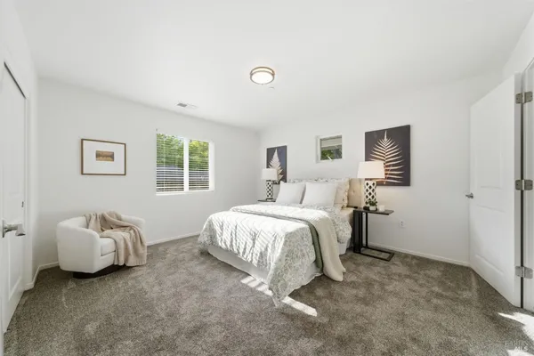 a spacious bedroom with a bed and a couch