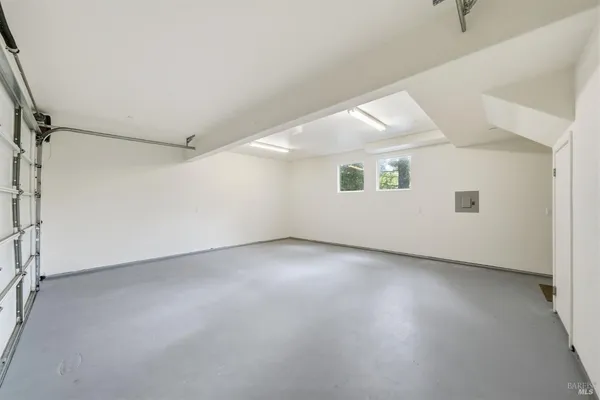 an empty room with a empty space and windows