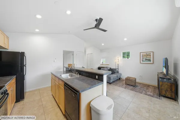 a kitchen with a stove a refrigerator and a sink