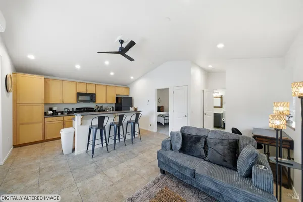 a living room with furniture and kitchen view