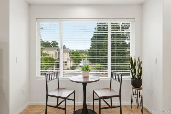 a view of a room with a window and dining table