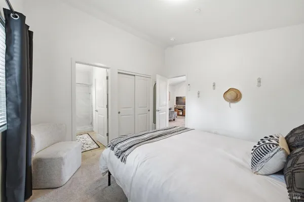a bedroom with a bed and a painting on the wall