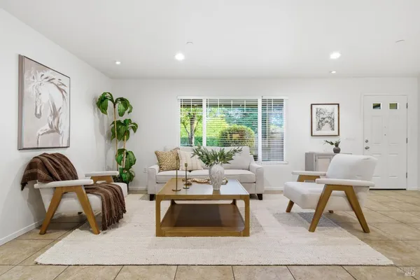 a living room with furniture rug and window