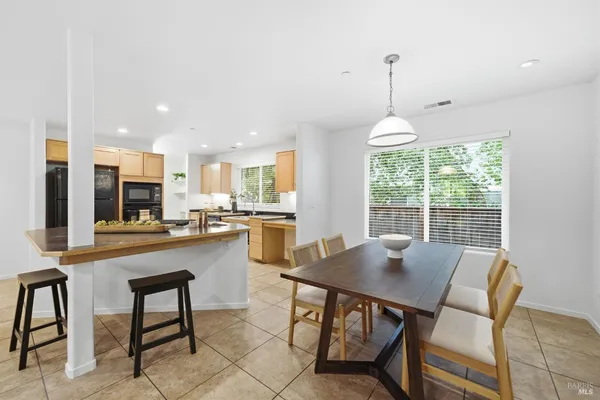 a dining room with furniture and window