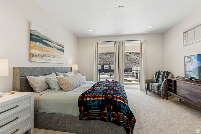 839 Walker Way St. George, UT 84770 - Photo 12 of 32 Carpeted room featuring a white wall finish, recessed lighting, and a glass door leading to a balcony