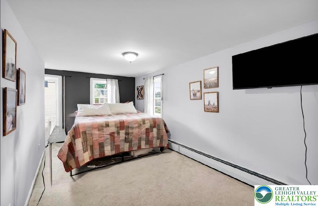 7281 Decatur Street New Tripoli, PA 18066 - Photo 12 of 24 a spacious bedroom with a bed and a flat screen tv