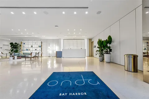 a lobby with furniture and a potted plant