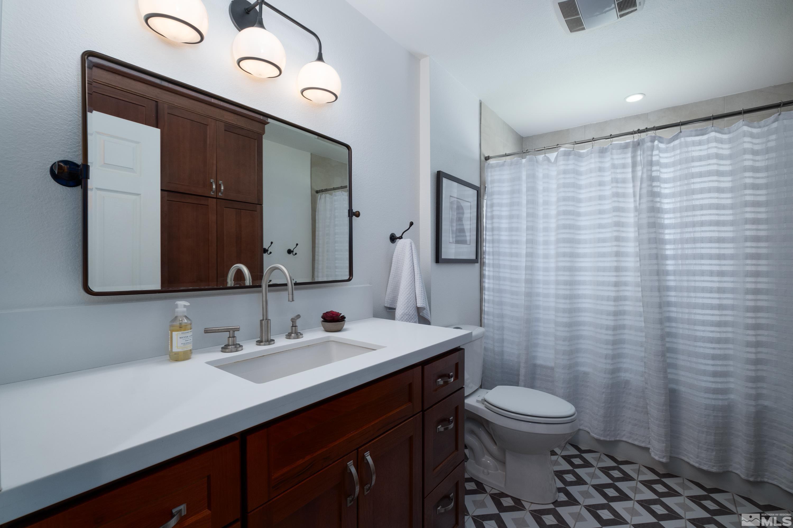 330 Chevy Chase Street Reno, NV 89509 - Photo 12 of 40 a bathroom with a sink a toilet and mirror