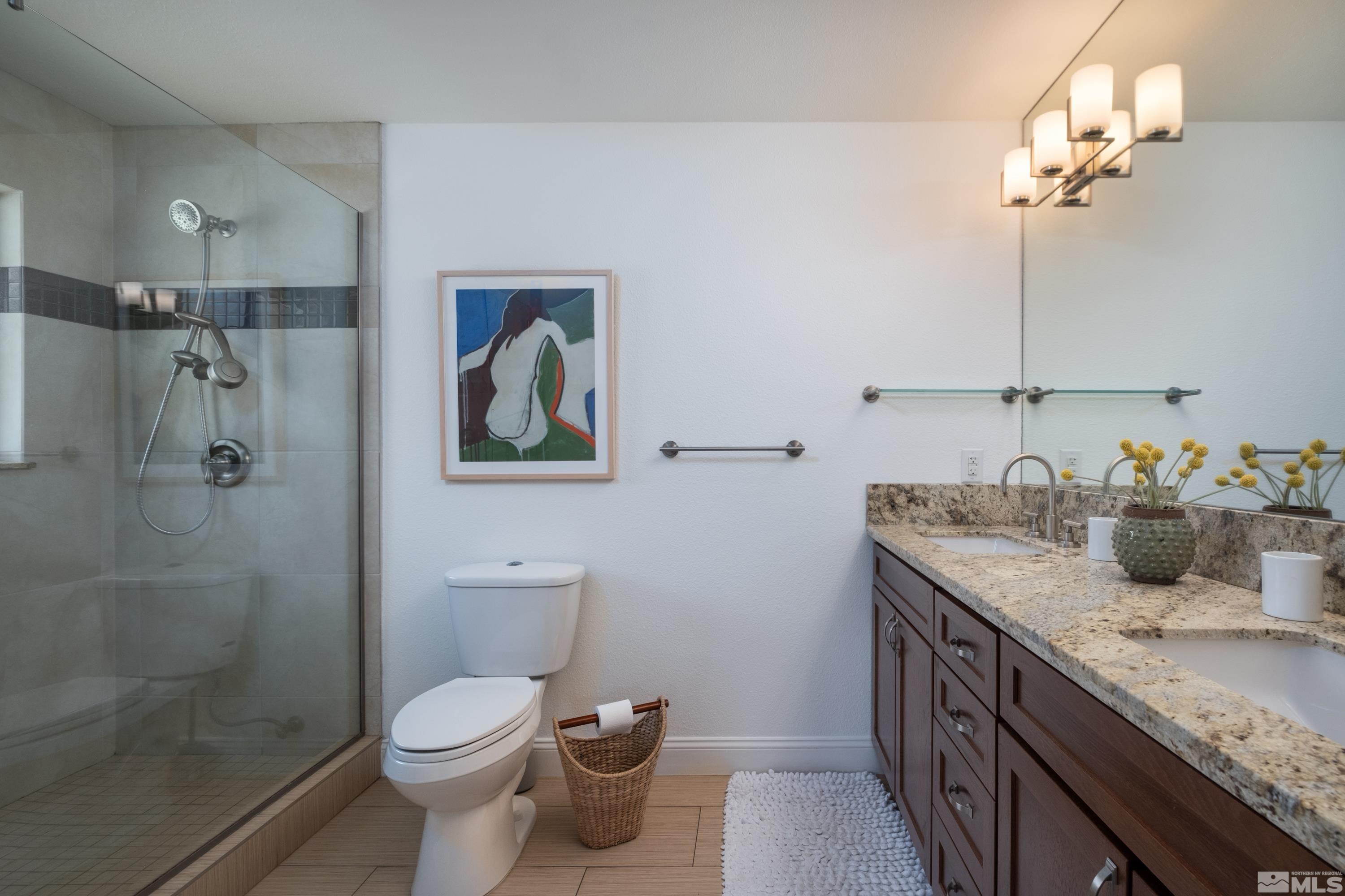 330 Chevy Chase Street Reno, NV 89509 - Photo 19 of 40 a bathroom with a granite countertop sink a toilet and shower