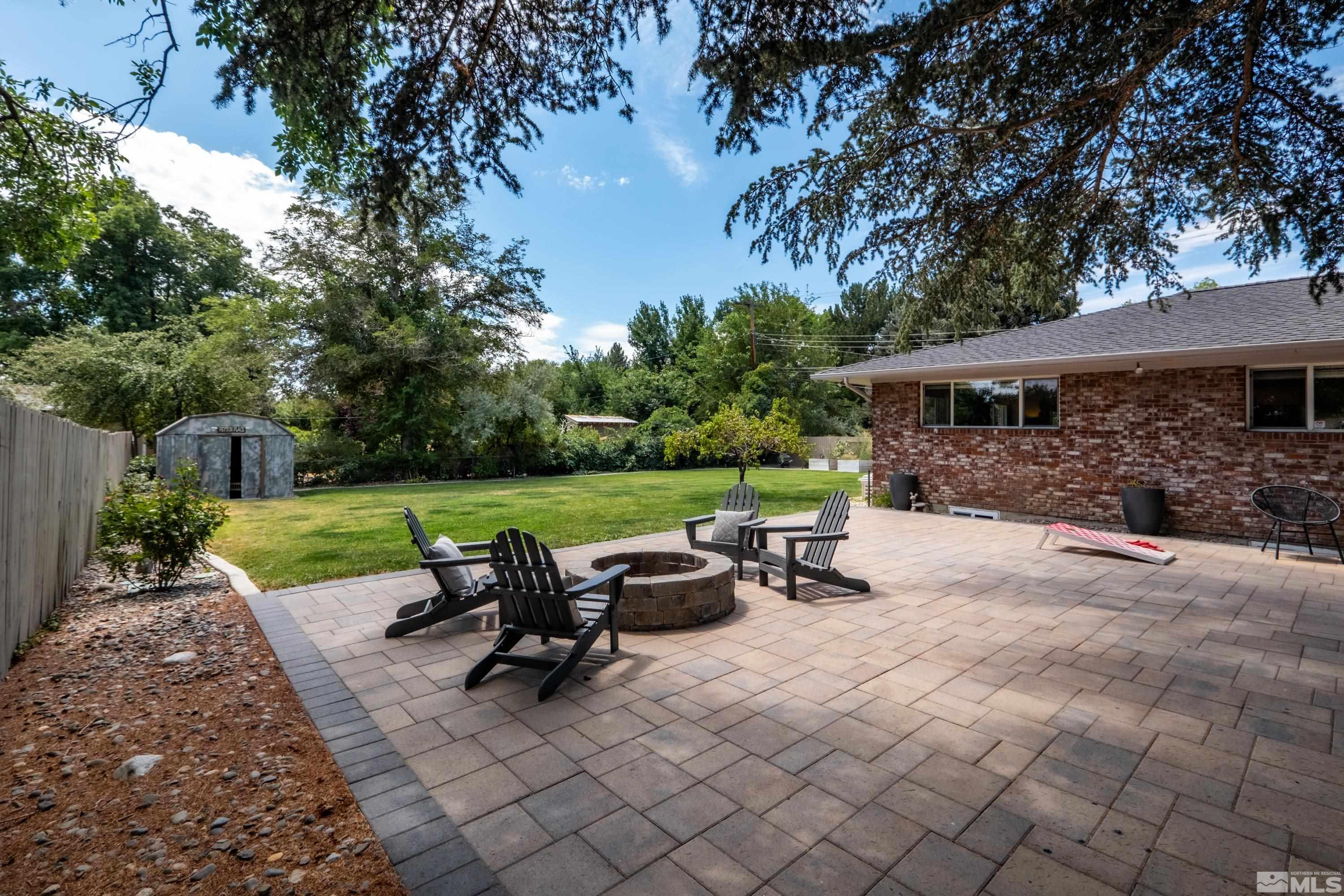 330 Chevy Chase Street Reno, NV 89509 - Photo 31 of 40 a view of a patio with table and chairs potted plants and a large tree
