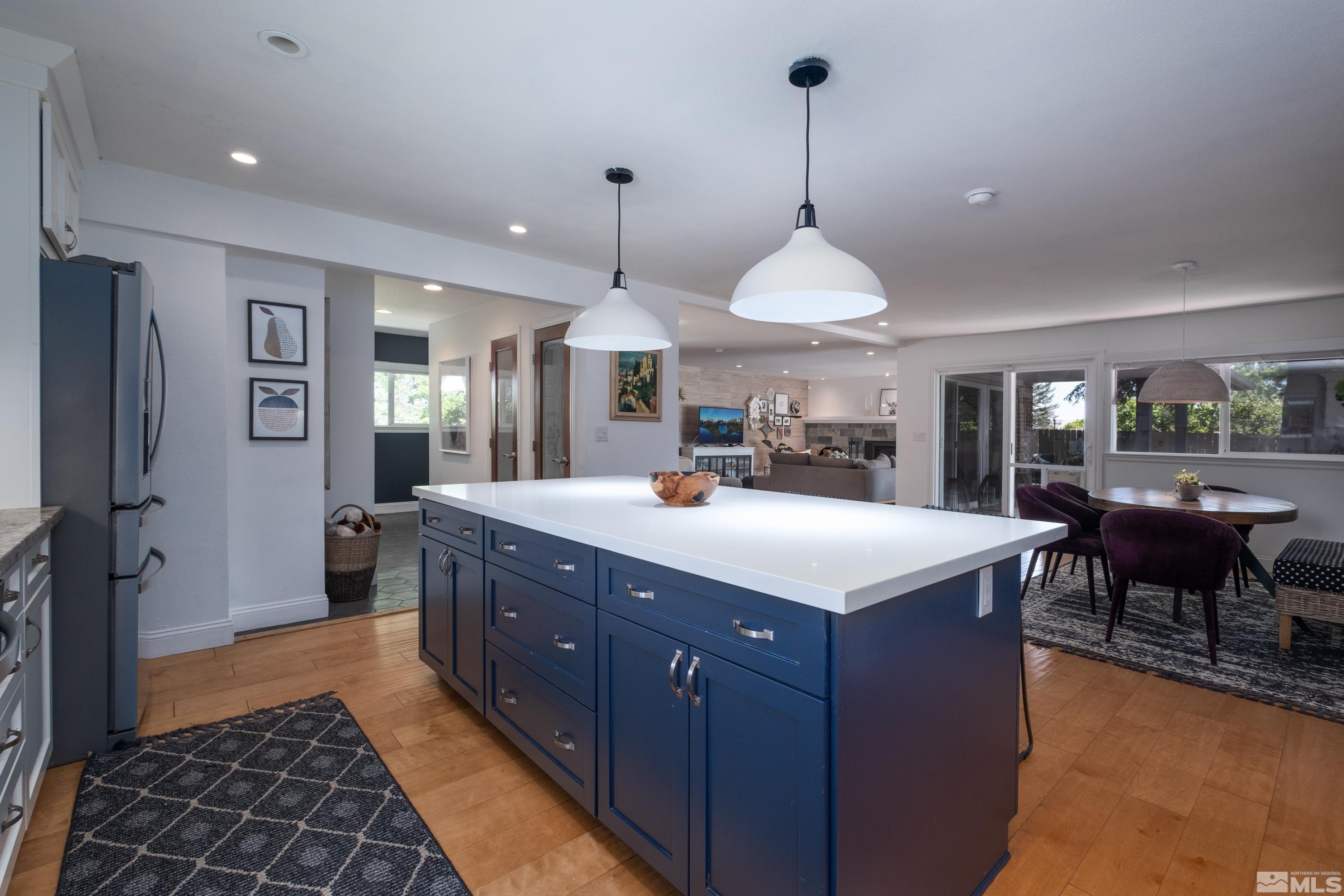 330 Chevy Chase Street Reno, NV 89509 - Photo 8 of 40 a large kitchen with kitchen island a counter a sink a counter space and a fireplace