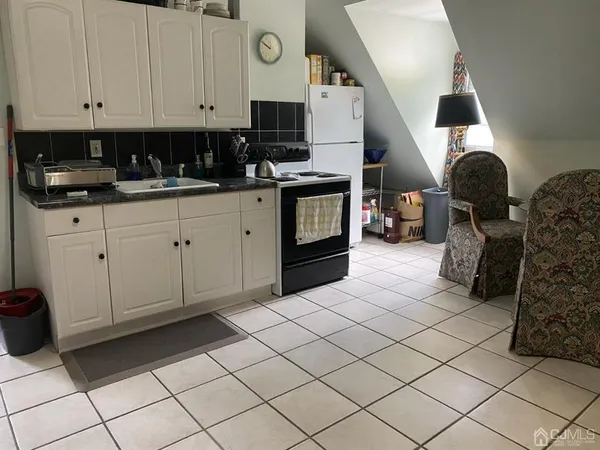 a kitchen with cabinets and window