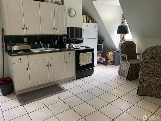 a kitchen with cabinets and window