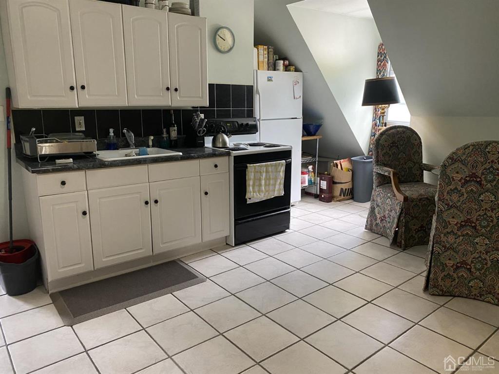 531 West 8th Street, Unit D Plainfield, NJ 07060 - Photo 3 of 10 a kitchen with cabinets and window