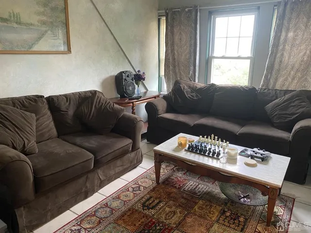 a living room with furniture a couch and a window