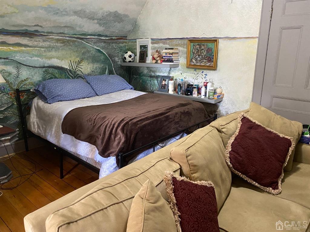 531 West 8th Street, Unit D Plainfield, NJ 07060 - Photo 6 of 10 a bedroom with a bed and cupboard