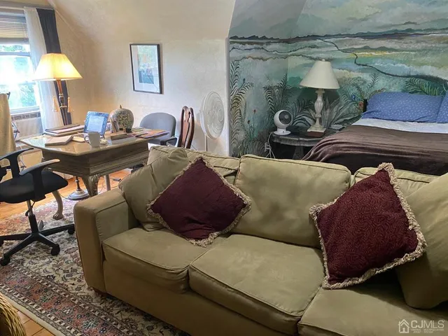 a living room with furniture and a lamp