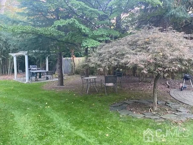 a view of a chair and table in backyard of the house