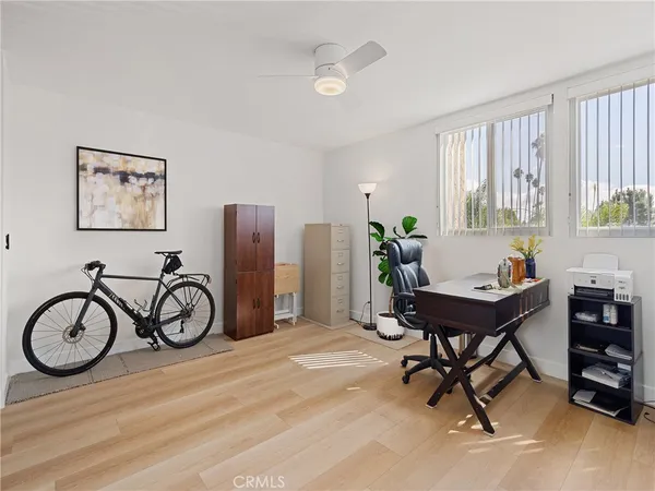 a view of a workspace with furniture and a window