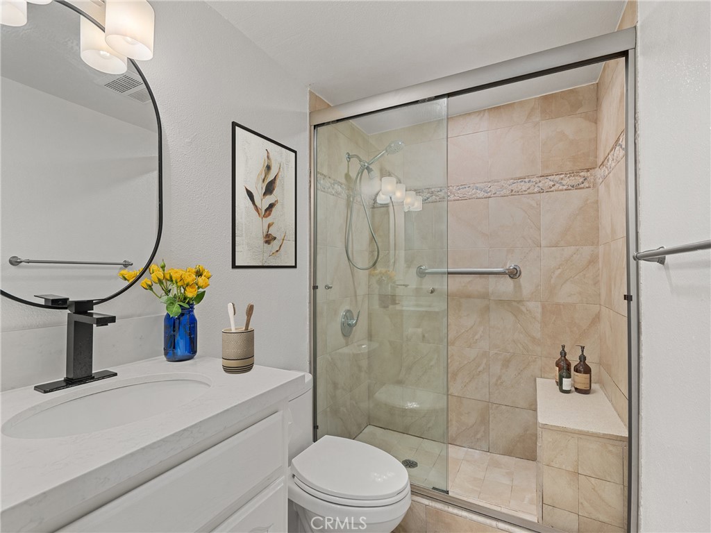 1 3rd Place, Unit 2 Long Beach, CA 90802 - Photo 18 of 39 a bathroom with a shower sink vanity mirror and toilet