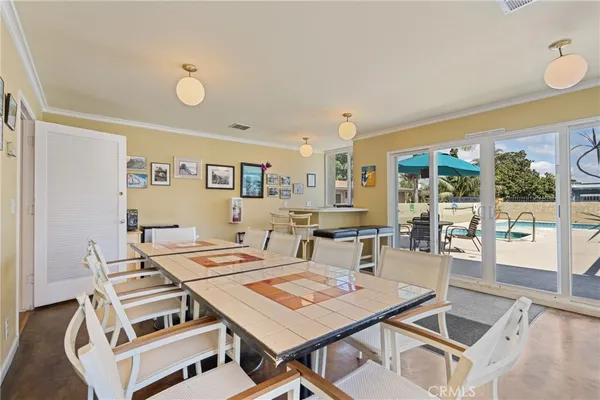 a view of a dining room with furniture wooden floor and chandelier