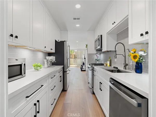 a kitchen with kitchen island granite countertop counter space stainless steel appliances and cabinets