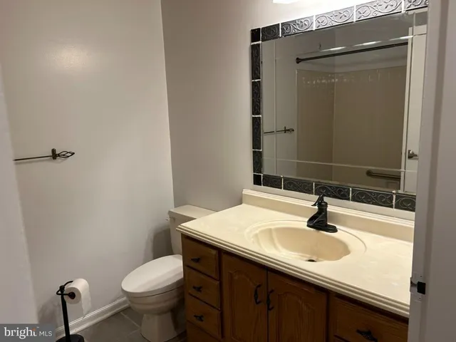a bathroom with a sink toilet and mirror