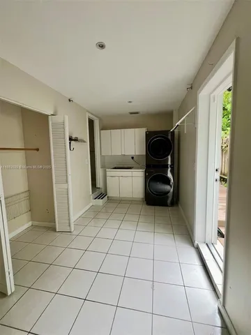 a view of a storage & utility room with fridge