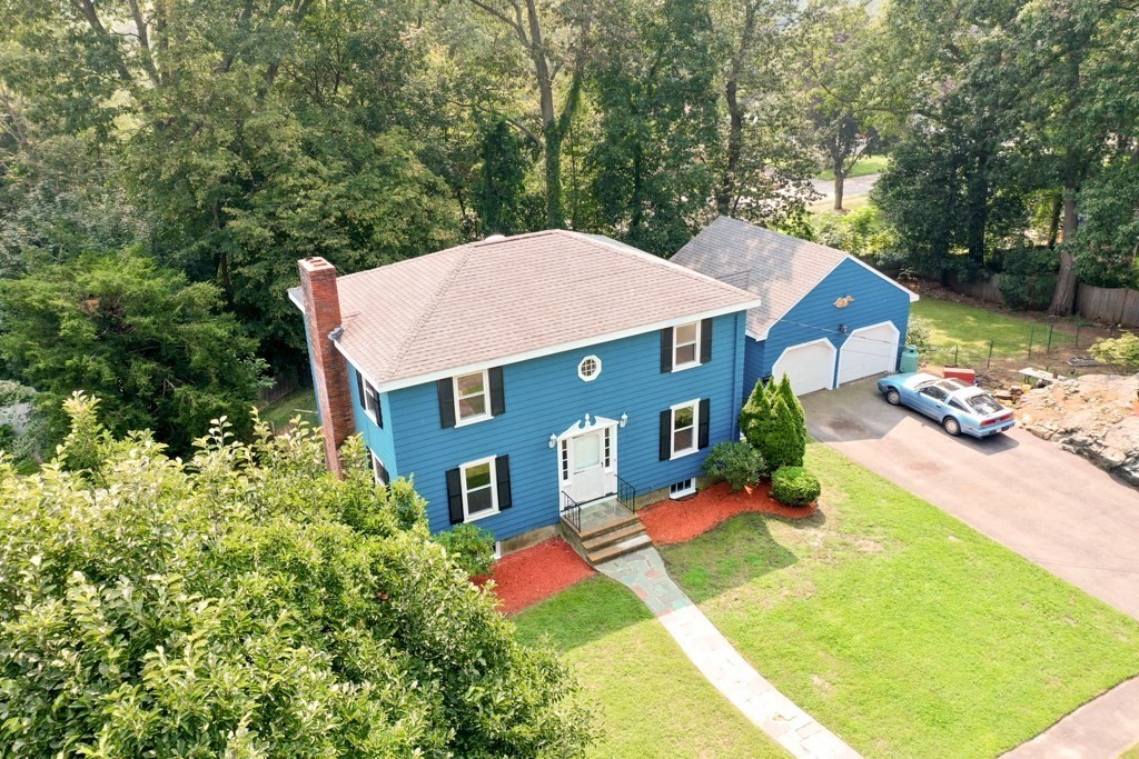 8 Michael Road Wakefield, MA 01880 - Photo 1 of 35 an aerial view of a house with swimming pool and red chairs