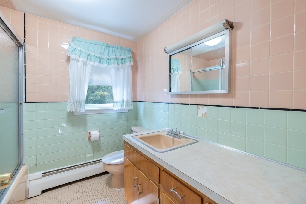 8 Michael Road Wakefield, MA 01880 - Photo 11 of 35 a bathroom with a sink a toilet and a mirror