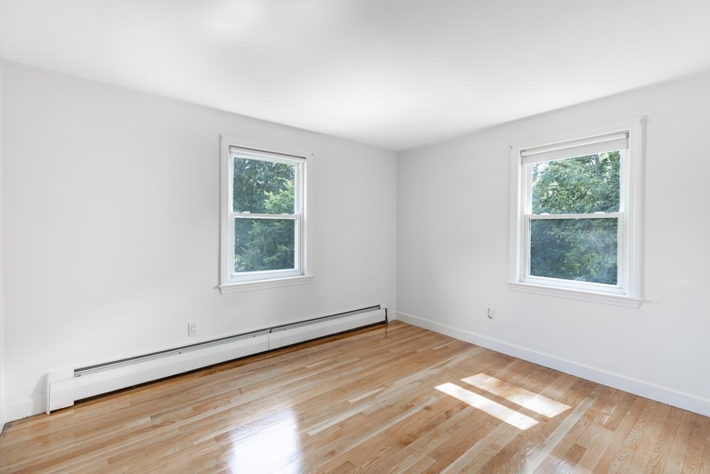 8 Michael Road Wakefield, MA 01880 - Photo 19 of 35 an empty room with wooden floor and windows