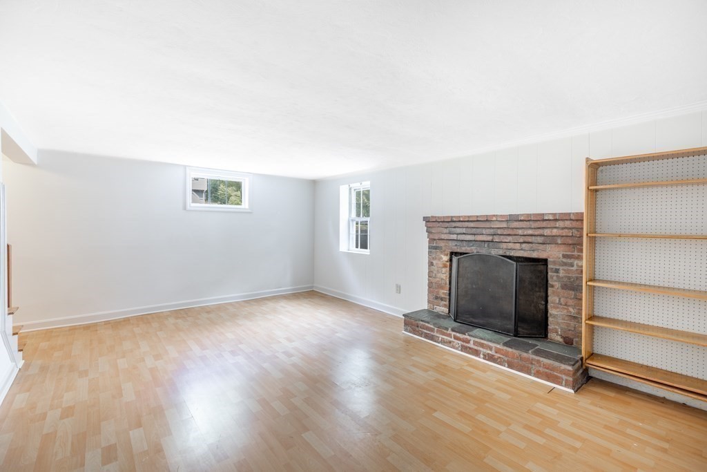 8 Michael Road Wakefield, MA 01880 - Photo 22 of 35 a view of an empty room with wooden floor fireplace and a window