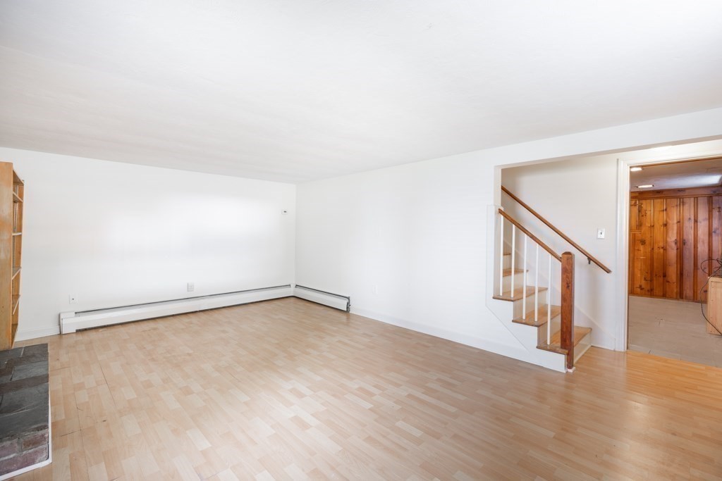 8 Michael Road Wakefield, MA 01880 - Photo 23 of 35 a view of an empty room with wooden floor and stairs