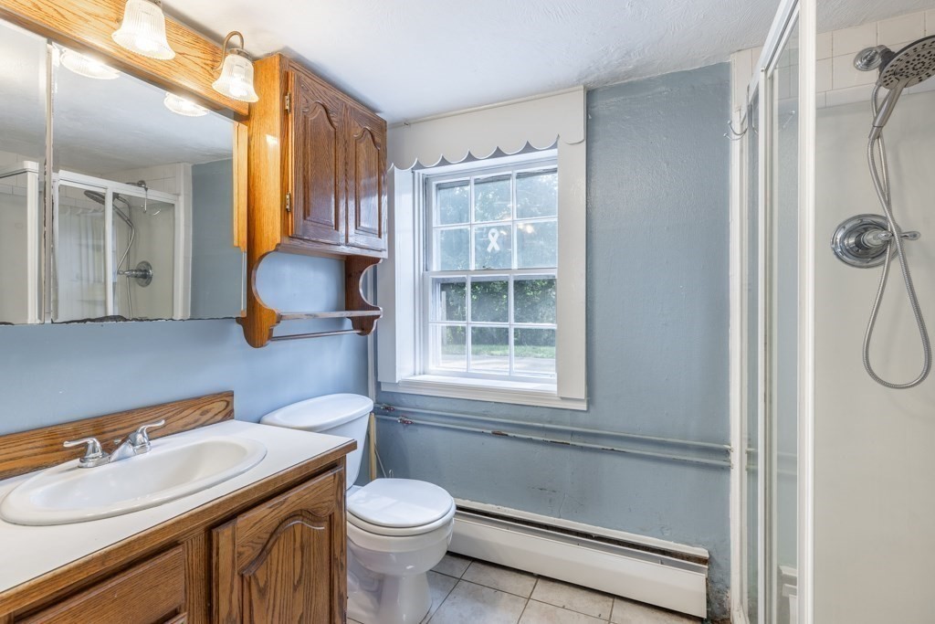 8 Michael Road Wakefield, MA 01880 - Photo 27 of 35 a bathroom with a sink toilet a mirror and shower