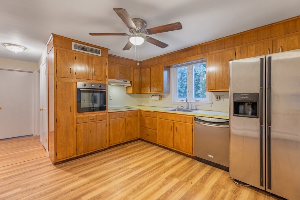 8 Michael Road Wakefield, MA 01880 - Photo 5 of 35 a kitchen with refrigerator cabinets and wooden floor