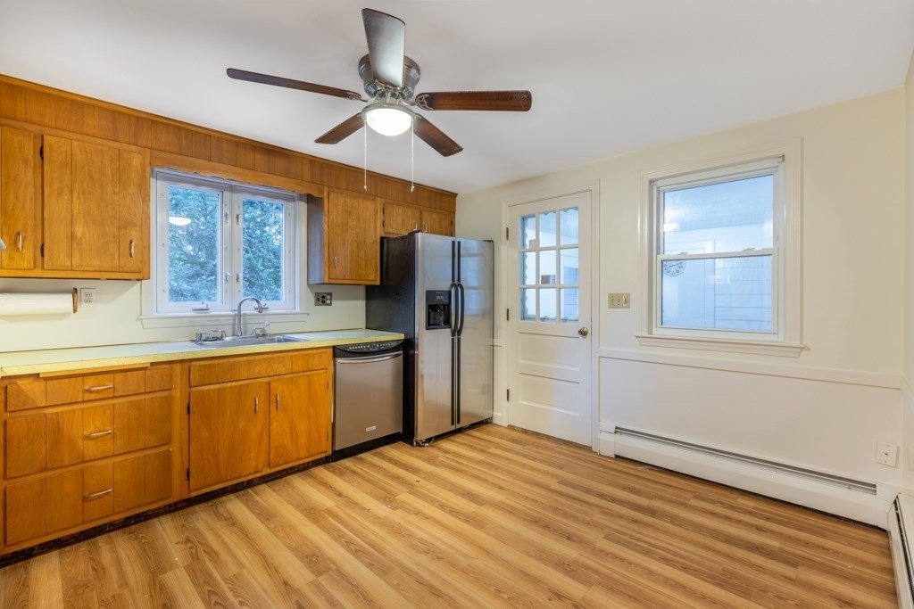 8 Michael Road Wakefield, MA 01880 - Photo 6 of 35 a kitchen with stainless steel appliances granite countertop a refrigerator a sink dishwasher stove and wooden cabinets
