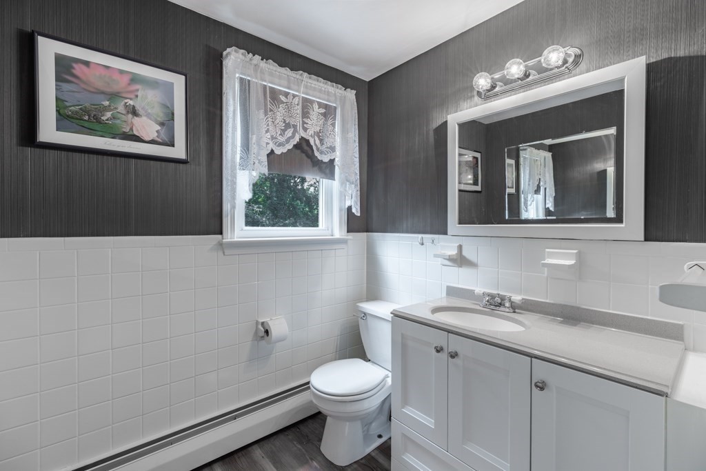 8 Michael Road Wakefield, MA 01880 - Photo 7 of 35 a bathroom with a toilet a sink and mirror