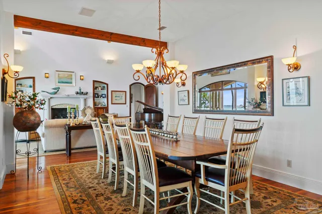 a dining room with furniture a rug and wooden floor