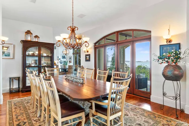a dining room with furniture potted plants and wooden floor