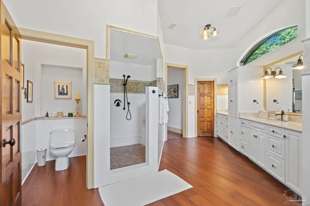 a bathroom with a toilet sink and mirror