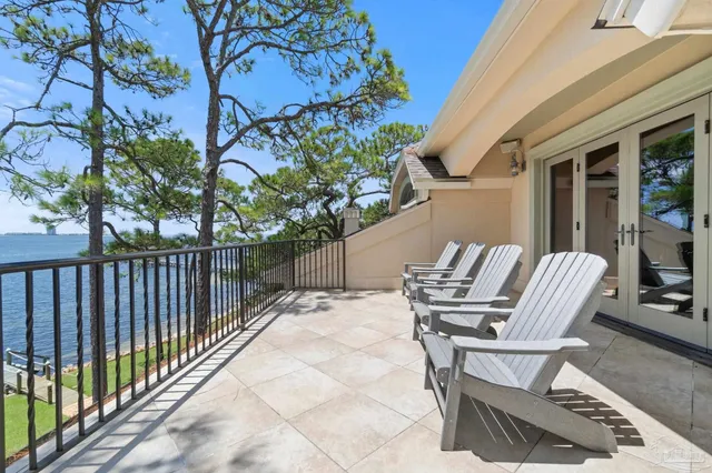 a living room with patio furniture and a potted plant