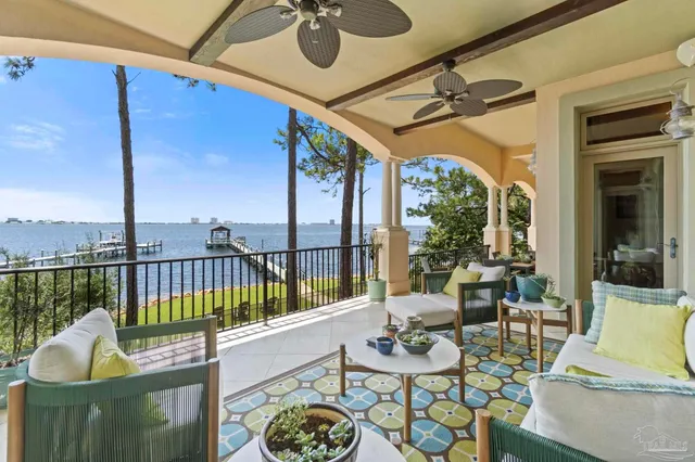 a view of a balcony dining table and chairs