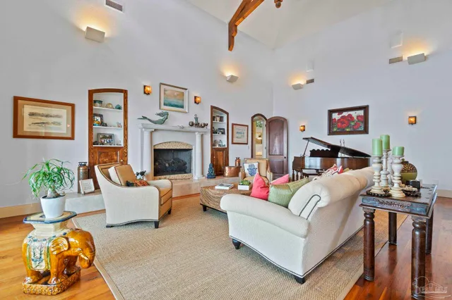 a living room with furniture fireplace and potted plants