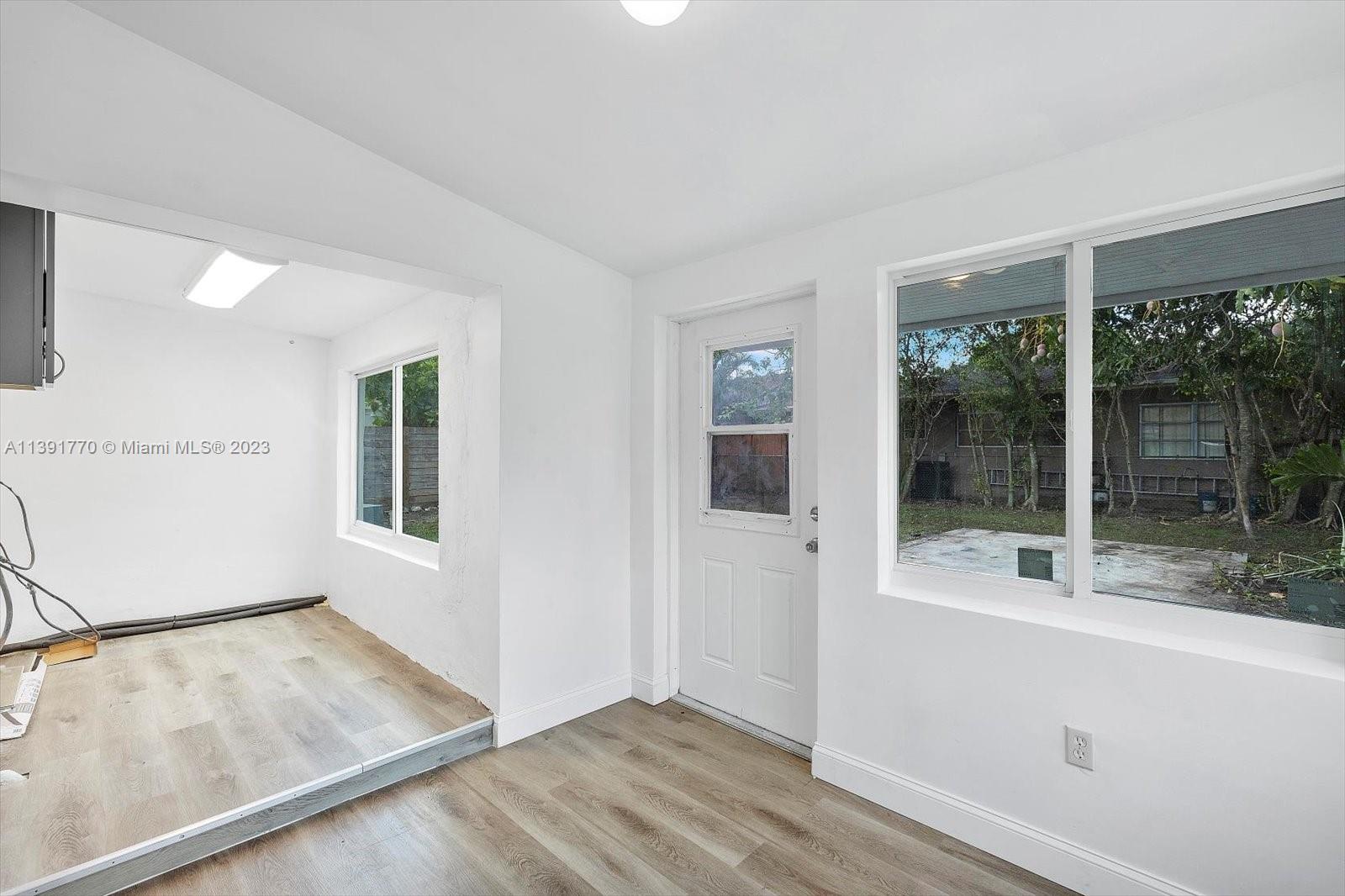 6110 Southwest 20th Street Miami, FL 33155 - Photo 12 of 29 an empty room with wooden floor and windows