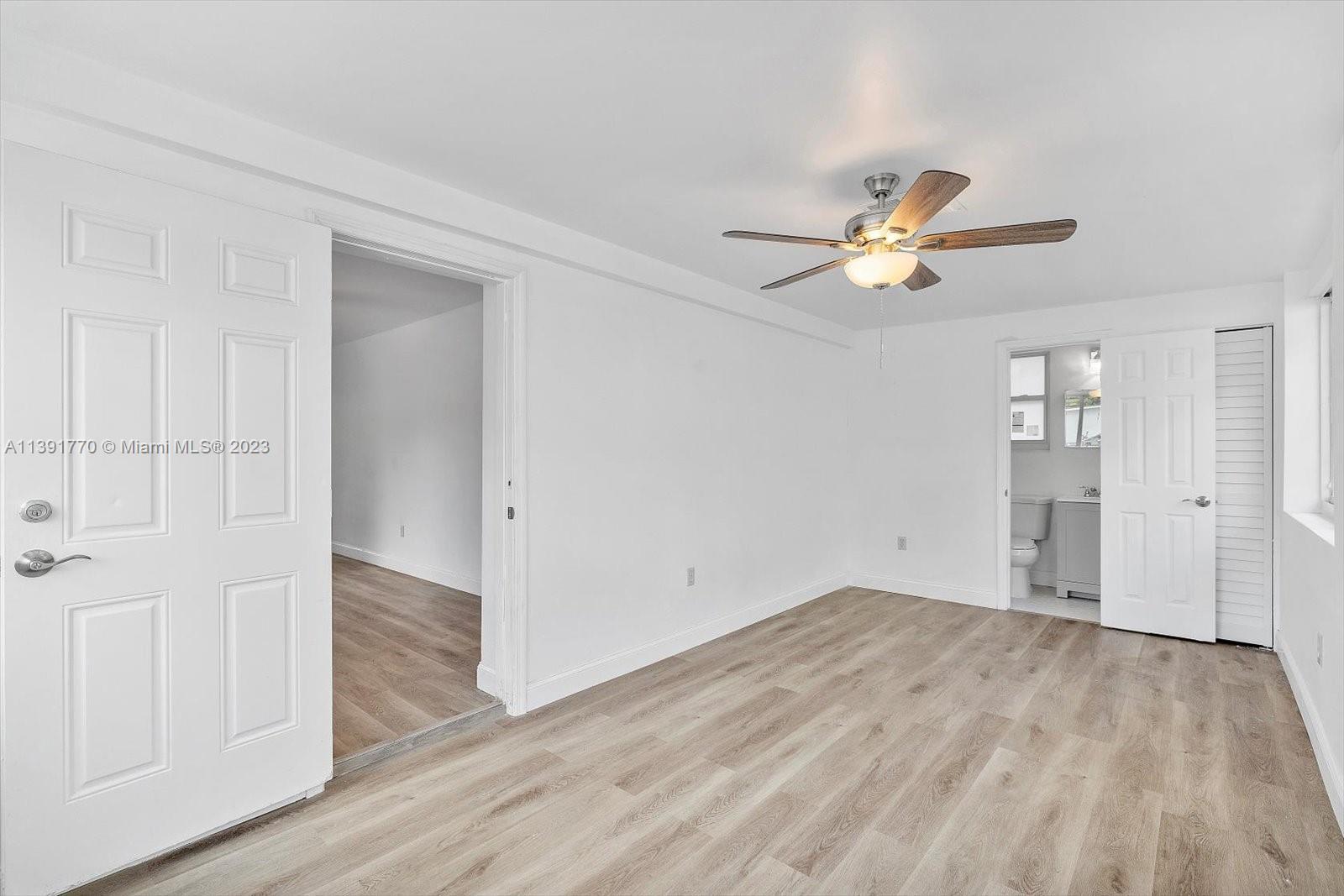 6110 Southwest 20th Street Miami, FL 33155 - Photo 16 of 29 wooden floor in an empty room with a window